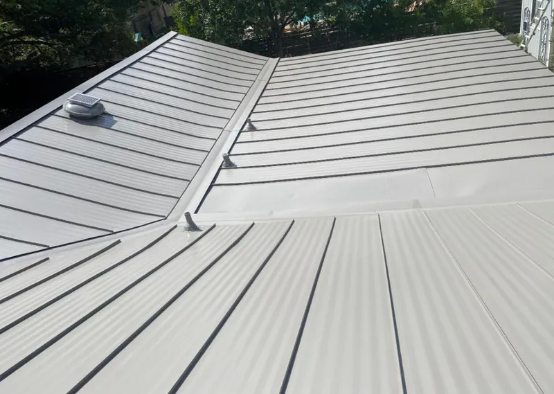 Solar attic fan installed on a metal roof for Roof Ventilation in East Lake-Orient Park